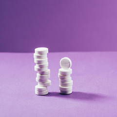 close up view of arranged pills on purple background