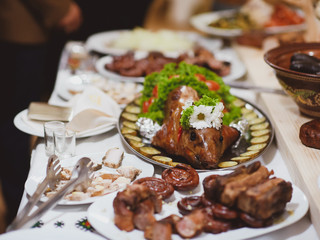 roast pig with vegetables on a banquet table, Ukrainian dish