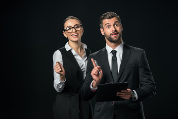businesspeople having idea and doing paperwork together, isolated on black