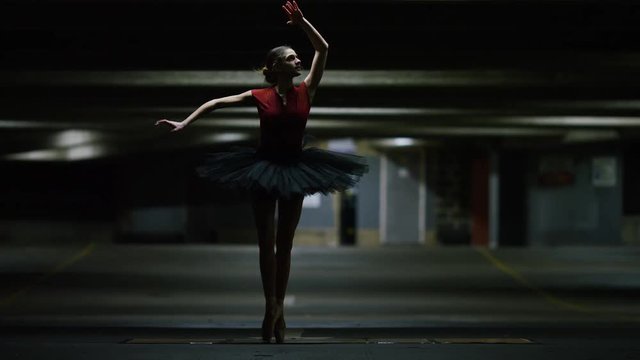 Young ballet dancer, dancing on pointe in a car park