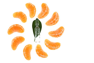 Vitamin C.  glass ampoule with vitamin C on mandarin leaves and slices of fresh manarin on a white background. Health and Beauty	