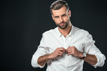 handsome man wearing white shirt, isolated on black