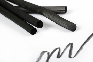 Charcoal artwork equipment on a white paper