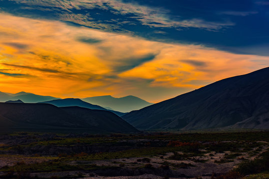 Hilly mountains in the valley, amazing sky at sunset © Vastram