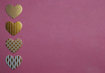 White and golden heart-shaped decorations on pink background. Valentine's Day concept. Greeting card background.