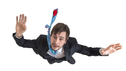 Young businessman falling down in free fall. Isolated on white background.