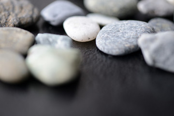 Obraz na płótnie Canvas Scattered stones on a dark background close up
