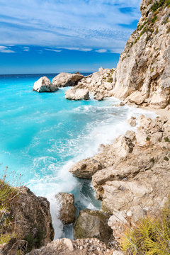 Lefkada Island cliffs with rough sea and clear bluew waves