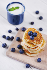 Pancakes with blueberry on cutting board