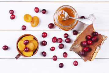 Fototapeta na wymiar Jar of apricot jam on wooden table .
