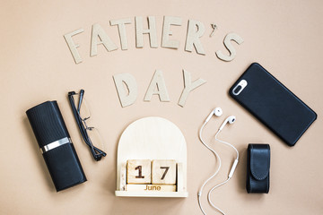Father's Day. Men's accessories on a beige background. International holiday on June 17, 2018