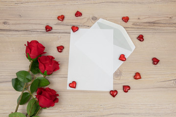 Valentines Day, Red roses with a blank invitation card and red hearts on wooden background, decoration for 
Valentines Day, wedding day concept