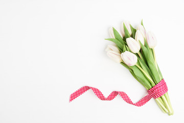 White tulips bouquet on white wooden background. Copy space, top view