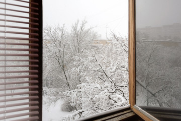 Snowfall in the city, the view from the window