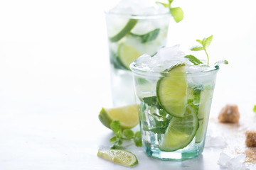 Mojito Cocktail.Mint, lime, ice, cane sugar ingredients for making  on a white background.Cold Drink.Top View.Copy space for Text.selective focus.