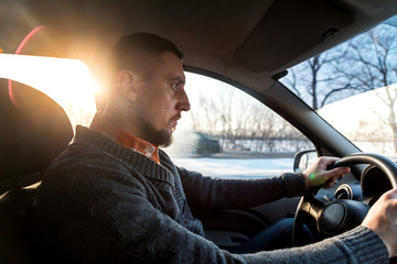 Fototapeta premium a man drives a car in the winter in conditions of ice