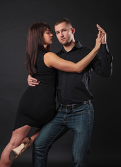 Couple dancing on a black background.