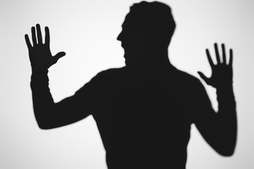 scary blurry shadow of person screaming on grey