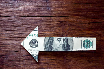 arrow money on wooden - Financial direction concept