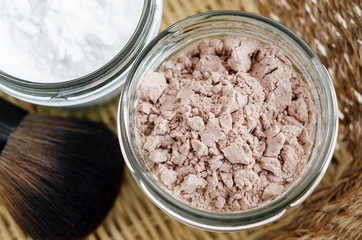 Mineral homemade powder foundation or dry shampoo in a grass jar. DIY cosmetics. Top view, close up, copy space.