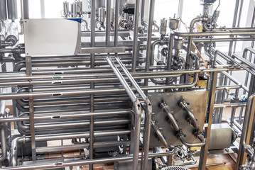 Stainless steel pipes in the factory. Construction on food production, Abstract industry background.