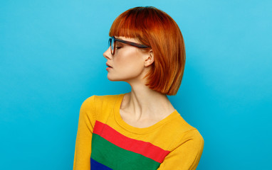 Face profile of young woman with glasses and red hair