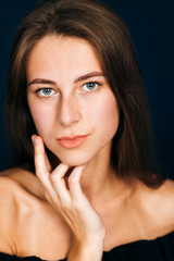 Fototapeta premium Portrait beautiful girl on a dark studio background