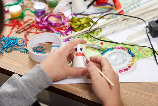 Child make crafts and toys, handmade concept. Artwork workplace with creative accessories.
