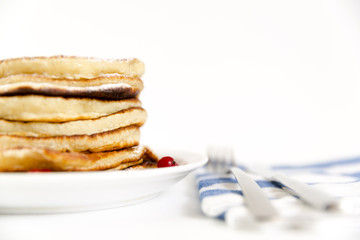 Stack of pancakes with berries and sugar