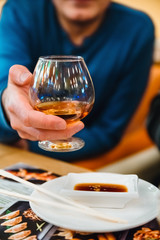 Man holding a glass of alcohol drink whiskey