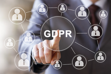 Businessman presses button GDPR Data Protection Regulation on virtual digital electronic user interface.