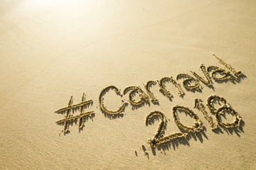 Message for Carnaval 2018 written on a smooth sand beach 