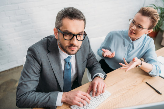 business colleagues working with computer together at modern office