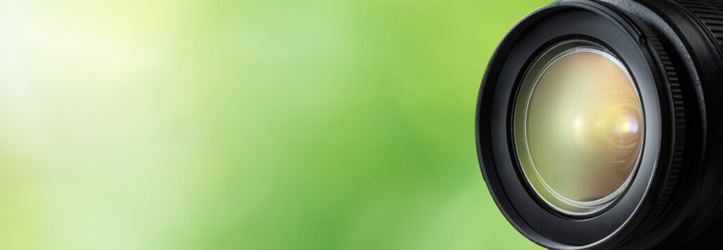 Camera lens close up and green background