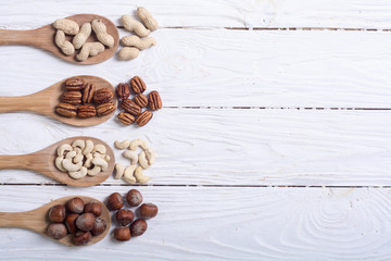 Mix of nuts in wooden spoon