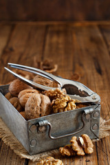Fresh walnuts in a box on a  wooden table
