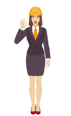 Businesswoman in construction helmet showing a okay hand sign