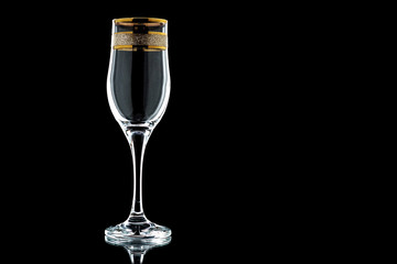 Fototapeta glass of wine with a gold rim  on a black background (isolate). obraz