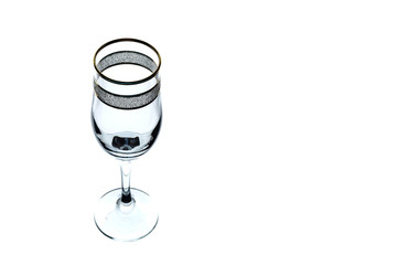 empty glass of wine with gold rim on white background (isolate).