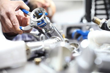 hands plumber at work in a bathroom, plumbing repair service, assemble and install concept