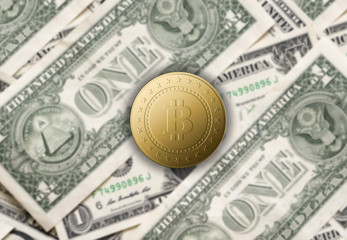 Golden bitcoins on the background of dollars bills
