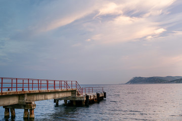Close-up of the shipping pier on the sea at dawn.