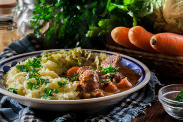 Traditional irish stew served with potatoes and cabbage