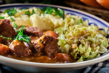 Traditional irish stew served with potatoes and cabbage