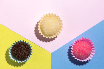 Brigadeiro Beijinho and Bicho de Pe: sweets from Brazil. Child birthday party. Flat design of candy ball on color background.
