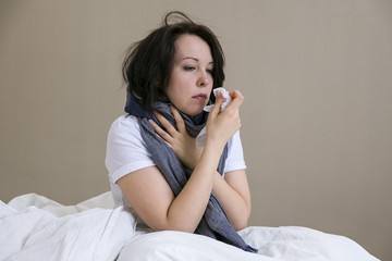 Young girl sick in bed with temperature. runny nose, cough, stay home