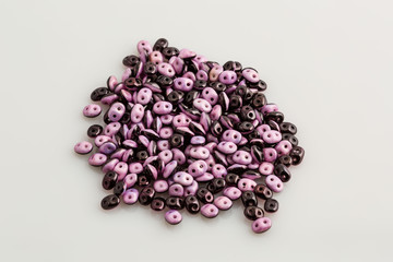 pile of two toned purple beads used to create jewelry