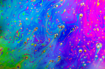 Beautiful psychedelic abstraction formed by light on the surface of a soap bubble