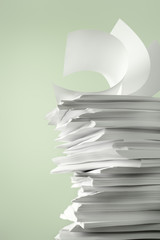 Stack of Papers against a plain color background