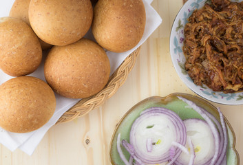 Ingredients for pulled pork sandwich with BBQ sauce and onion.